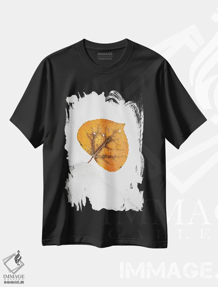 تیشرت مشکی طرح دار برگ نارنجی روی تپه برفی، عکاسی ماکرو اثر نیک ریو | فروشگاه ایماژ