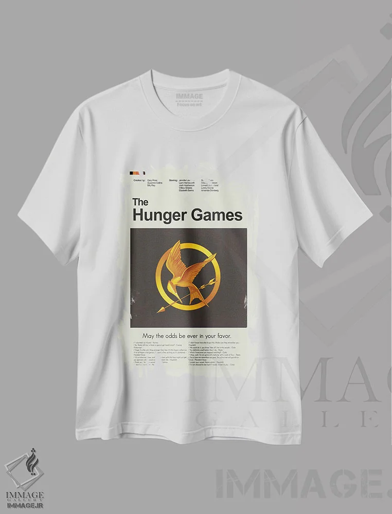 تیشرت سفید طرح دار – تیشرت فیلم ,بازی های عطش اثر پرینتس اند گیگلز اثر اَرین هیگرمن immage.ir