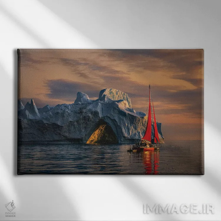 تابلو غروب قایق بادبانی قرمز کنار کوه یخی گرینلند (قسمت اول) اثر الکس جی پرز - نمای روبهرو روی دیوار