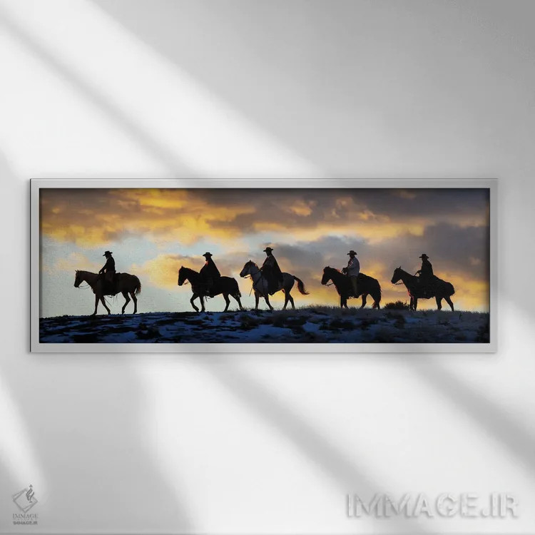 تابلو Shell, Wyoming Hideout Ranch Cowboys And Cowgirls Silhouetted Against Sunset Riding On Ridgeline II,آمریکا، شل، وایومینگ، کابویها و کابوی دختران در حال سواری سیلوئتشده مقابل غروب بر خطالرأس ۲ اثر دارل گالین - نمای قابدار سفید