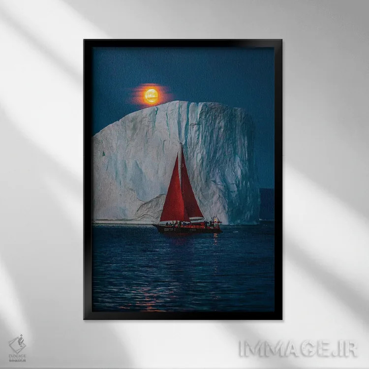 تابلو قایق بادبانی قرمز کنار کوه یخی گرینلند با ماه کامل سرخ (قسمت دوم) اثر الکس جی پرز - نمای قابدار مشکی