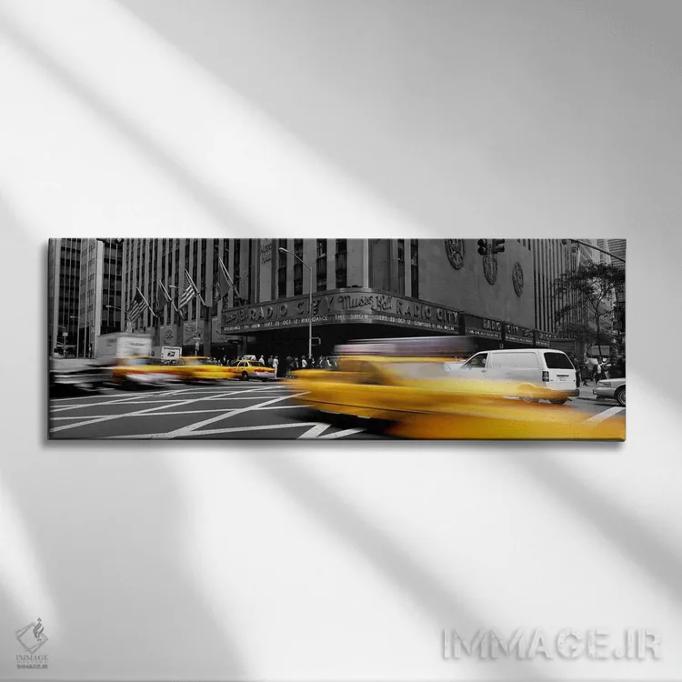 تابلو Radio City Music Hall, New York City, New York State, USA Color Pop,ماشینها جلوی ساختمان سالن موسیقی رادیو سیتی نیویورک آمریکا با رنگ تقویتی اثر پانورامیک ایمجز (استودیو عکاسی عریض) - نمای روبهرو روی دیوار