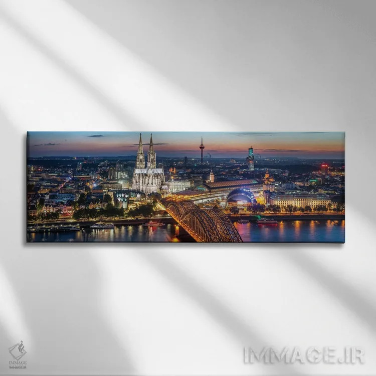 تابلو نمای هوایی از کلن با کلیسای جامع کلن و پل هوهنزولرن در شب اثر یان بکه - نمای روبهرو روی دیوار