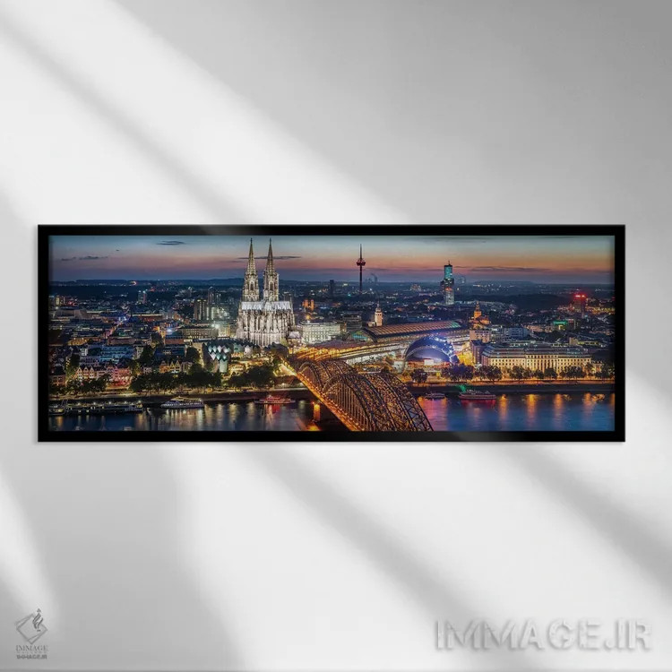 تابلو نمای هوایی از کلن با کلیسای جامع کلن و پل هوهنزولرن در شب اثر یان بکه - نمای قابدار مشکی