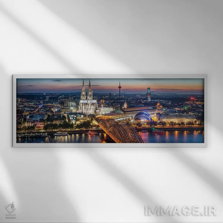 تابلو نمای هوایی از کلن با کلیسای جامع کلن و پل هوهنزولرن در شب اثر یان بکه - نمای قابدار سفید