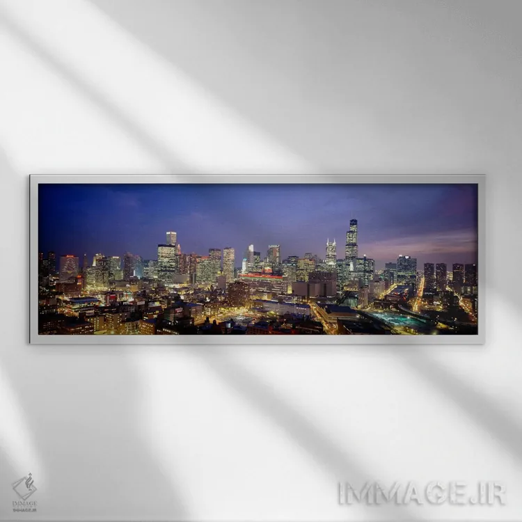 تابلو نمای بالا از ساختمانها روشنشده در غروب، شیکاگو، ایلینوی، ایالات متحده اثر پانورامیک ایمجز (استودیو عکاسی عریض) - نمای قابدار سفید