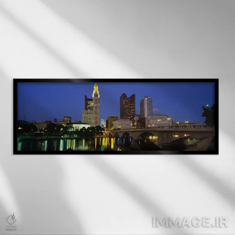 تابلو ساختمانهایی که در شب روشن شدهاند، کلمبوس، رودخانه سیتو، اوهایو، ایالات متحده اثر پانورامیک ایمجز (استودیو عکاسی عریض) - نمای قابدار مشکی