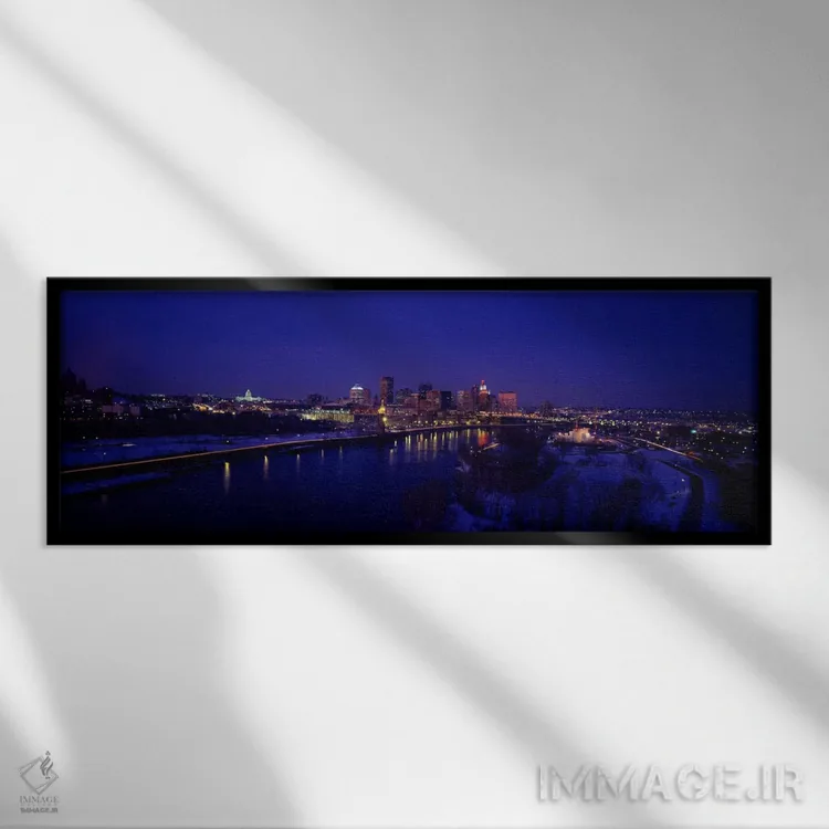 تابلو بازتاب ساختمانها در رودخانه در شب، رودخانه میسیسیپی، مینیاپولیس و سنت پل، مینهسوتا، آمریکا اثر پانورامیک ایمجز (استودیو عکاسی عریض) - نمای قابدار مشکی
