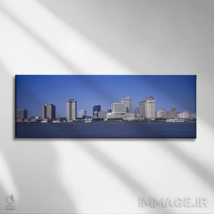 تابلو Mississippi River, New Orleans, Louisiana, USA,ساختمانها در کنار آب، رودخانه میسیسیپی، نیواورلئان، لوئیزیانا، آمریکا اثر پانورامیک ایمجز (استودیو عکاسی عریض) - نمای روبهرو روی دیوار