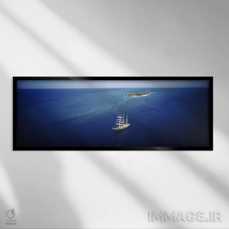 تابلو Heron Island, Great Barrier Reef, Queensland, Australia,نمای بالا از یک قایق بادبانی در اقیانوس، جزیره هرون، صخره بزرگ مرجانی، کوئینزلند، استرالیا اثر پانورامیک ایمجز (استودیو عکاسی عریض) - نمای قابدار مشکی