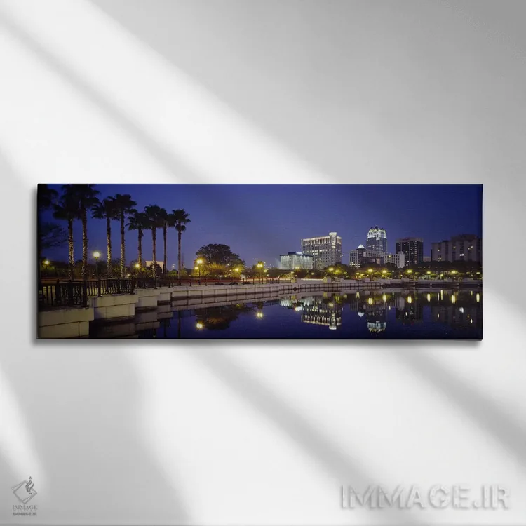 تابلو Orlando, Florida, USA,انعکاس ساختمانها در آب، اورلاندو، فلوریدا، ایالات متحده آمریکا اثر پانورامیک ایمجز (استودیو عکاسی عریض) - نمای روبهرو روی دیوار