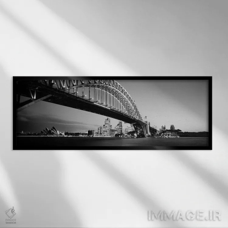 تابلو Sydney Harbor Bridge, Sydney, New South Wales, Australia (black & white),نمای زاویه پایین از یک پل، پل بندر سیدنی، سیدنی، نیو ساوت ولز، استرالیا (سیاه و سفید) اثر پانورامیک ایمجز (استودیو عکاسی عریض) - نمای قابدار مشکی