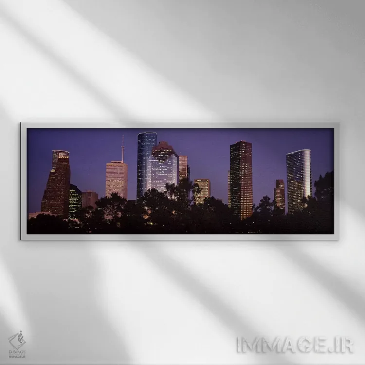 تابلو Harris county, Texas, USA,ساختمانهای روشنشده در شهر هنگام غروب، هیوستون، شهرستان هریس، تگزاس، آمریکا اثر پانورامیک ایمجز (استودیو عکاسی عریض) - نمای قابدار سفید