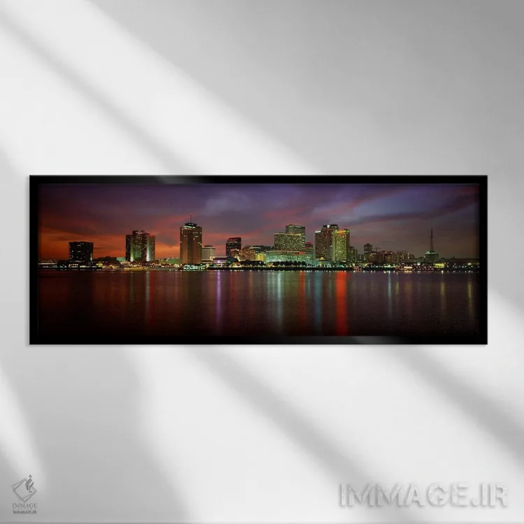 تابلو New Orleans, Louisiana, USA,ساختمانهای روشنشده در کنار آب، نیواورلئان، لوئیزیانا، آمریکا اثر پانورامیک ایمجز (استودیو عکاسی عریض) - نمای قابدار مشکی