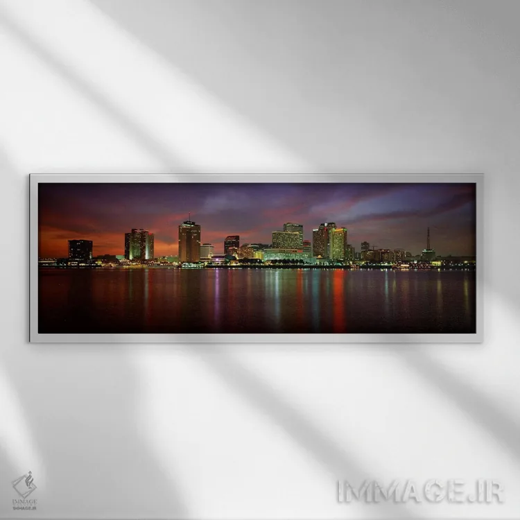 تابلو New Orleans, Louisiana, USA,ساختمانهای روشنشده در کنار آب، نیواورلئان، لوئیزیانا، آمریکا اثر پانورامیک ایمجز (استودیو عکاسی عریض) - نمای قابدار سفید