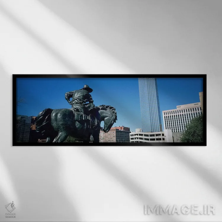 تابلو Dallas, Texas, USA,نما از زاویه پایین از یک مجسمه در مقابل ساختمانها، دالاس، تگزاس، آمریکا اثر پانورامیک ایمجز (استودیو عکاسی عریض) - نمای قابدار مشکی