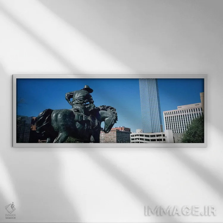 تابلو Dallas, Texas, USA,نما از زاویه پایین از یک مجسمه در مقابل ساختمانها، دالاس، تگزاس، آمریکا اثر پانورامیک ایمجز (استودیو عکاسی عریض) - نمای قابدار سفید