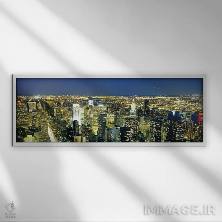 تابلو NYC, New York City, New York State, USA,نمای هوایی ساختمانهای روشن در غروب، منهتن، نیویورک، ایالات متحده اثر پانورامیک ایمجز (استودیو عکاسی عریض) - نمای قابدار سفید