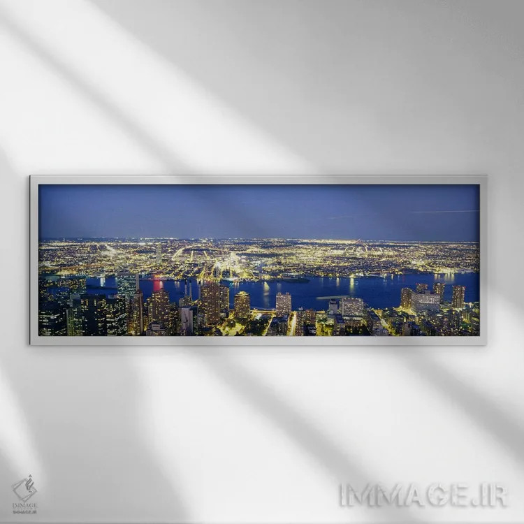 تابلو NYC, New York City, New York State, USA,نمای هوایی ساختمانهای روشن در غروب، منهتن، نیویورک، ایالات متحده اثر پانورامیک ایمجز (استودیو عکاسی عریض) - نمای قابدار سفید