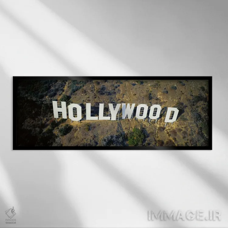 تابلو California, Los Angeles, Aerial view of Hollywood Sign at Hollywood Hills,ایالات متحده، کالیفرنیا، لسآنجلس، نمای هوایی تابلو هالیوود در تپههای هالیوود اثر پانورامیک ایمجز (استودیو عکاسی عریض) - نمای قابدار مشکی