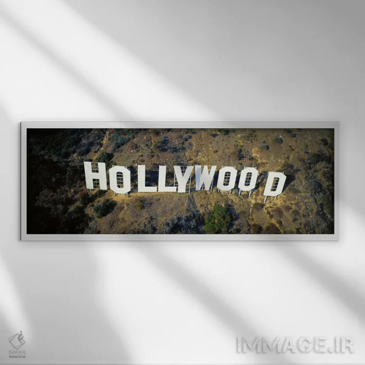 تابلو California, Los Angeles, Aerial view of Hollywood Sign at Hollywood Hills,ایالات متحده، کالیفرنیا، لسآنجلس، نمای هوایی تابلو هالیوود در تپههای هالیوود اثر پانورامیک ایمجز (استودیو عکاسی عریض) - نمای قابدار سفید