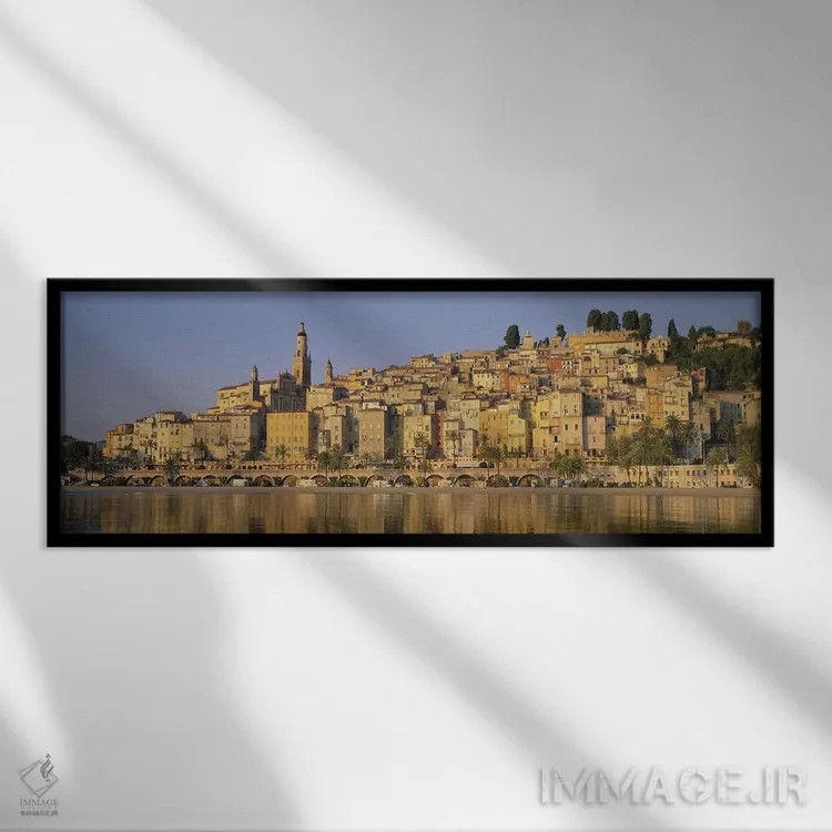 تابلو Eglise St-Michel, Menton, France,ساختمانها در کنار آب، کلیسای سنت میشل، منتون، فرانسه اثر پانورامیک ایمجز (استودیو عکاسی عریض) - نمای قابدار مشکی