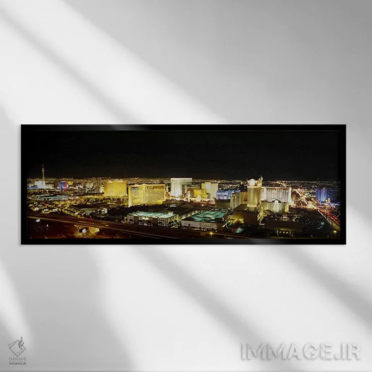تابلو Nevada, USA,نمای زاویه بالا از ساختمانهای روشنشده در شب، لاس وگاس، نوادا، ایالات متحده آمریکا اثر پانورامیک ایمجز (استودیو عکاسی عریض) - نمای قابدار مشکی