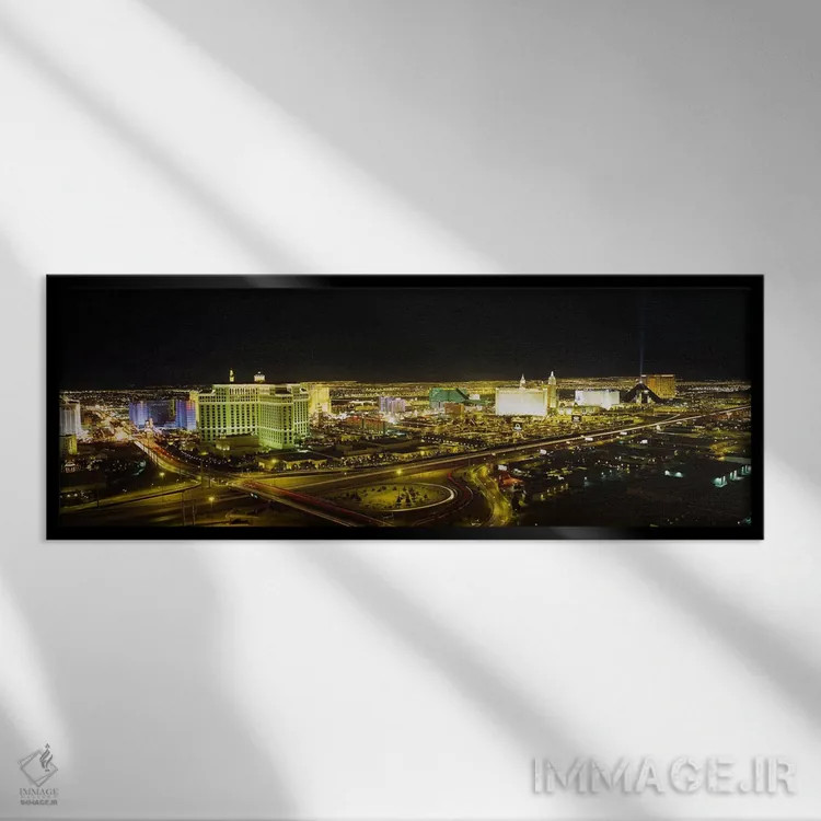 تابلو Nevada, USA,نمای زاویه بالا از ساختمانهای روشنشده در شب، لاس وگاس، نوادا، ایالات متحده آمریکا اثر پانورامیک ایمجز (استودیو عکاسی عریض) - نمای قابدار مشکی