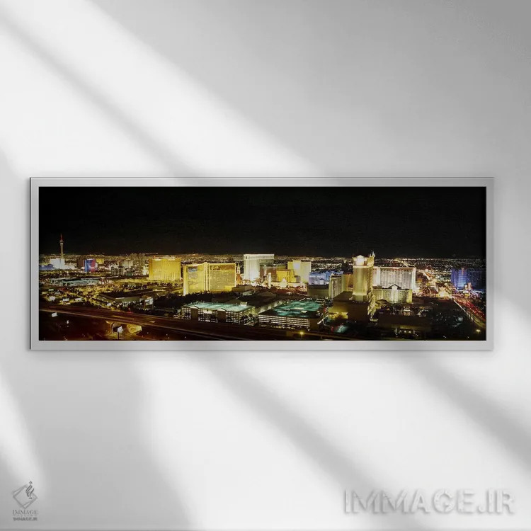 تابلو Nevada, USA,نمای زاویه بالا از ساختمانهای روشنشده در شب، لاس وگاس، نوادا، ایالات متحده آمریکا اثر پانورامیک ایمجز (استودیو عکاسی عریض) - نمای قابدار سفید