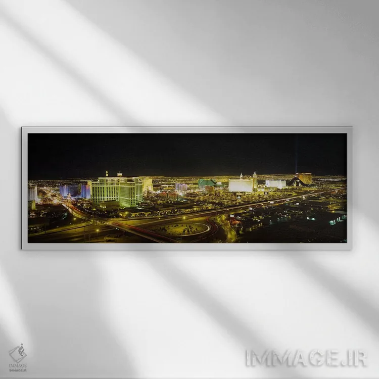 تابلو Nevada, USA,نمای زاویه بالا از ساختمانهای روشنشده در شب، لاس وگاس، نوادا، ایالات متحده آمریکا اثر پانورامیک ایمجز (استودیو عکاسی عریض) - نمای قابدار سفید