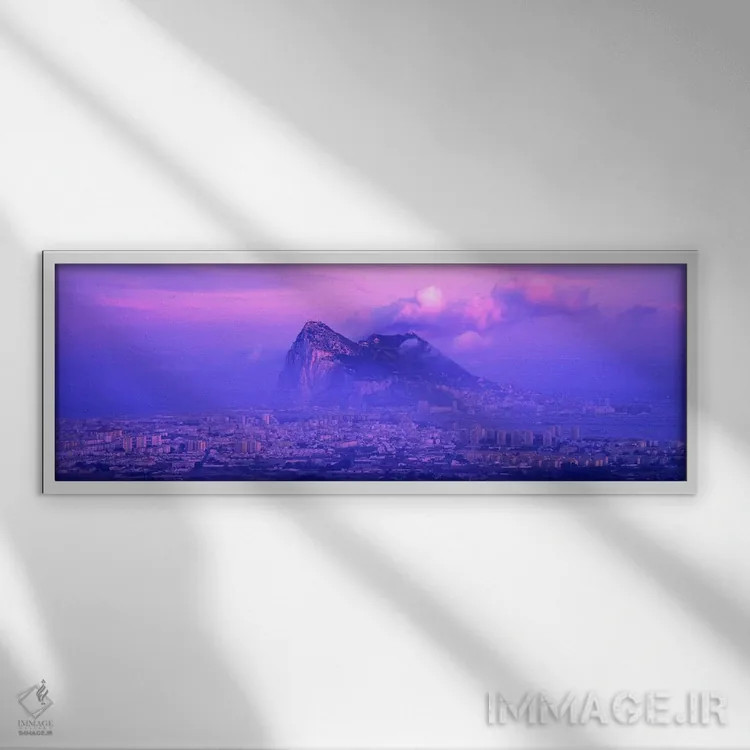 تابلو Rock Of Gibraltar, Iberian Peninsula, Gibraltar,غروب ابری بنفش، صخره جبلالطارق، شبهجزیره ایبری، جبلالطارق اثر پانورامیک ایمجز (استودیو عکاسی عریض) - نمای قابدار سفید