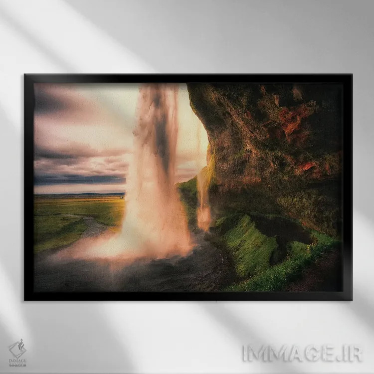 تابلو دکوراتیو دید آبشار سلجالاندسفوس از داخل غار در هنگام غروب، ایسلند اثر جورج اوزه - نمای قابدار مشکی