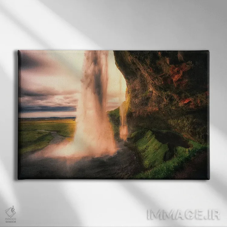 تابلو دکوراتیو دید آبشار سلجالاندسفوس از داخل غار در هنگام غروب، ایسلند اثر جورج اوزه - نمای روبهرو روی دیوار