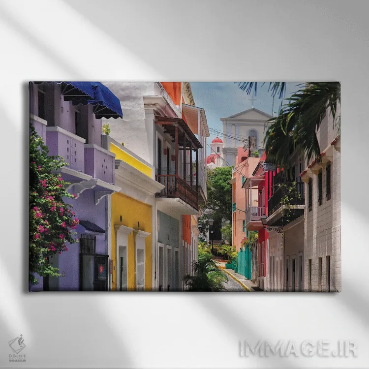 تابلو دکوراتیو خیابان های رنگارنگ سن خوان قدیمی، پورتوریکو اثر جورج اوزه - نمای روبهرو روی دیوار