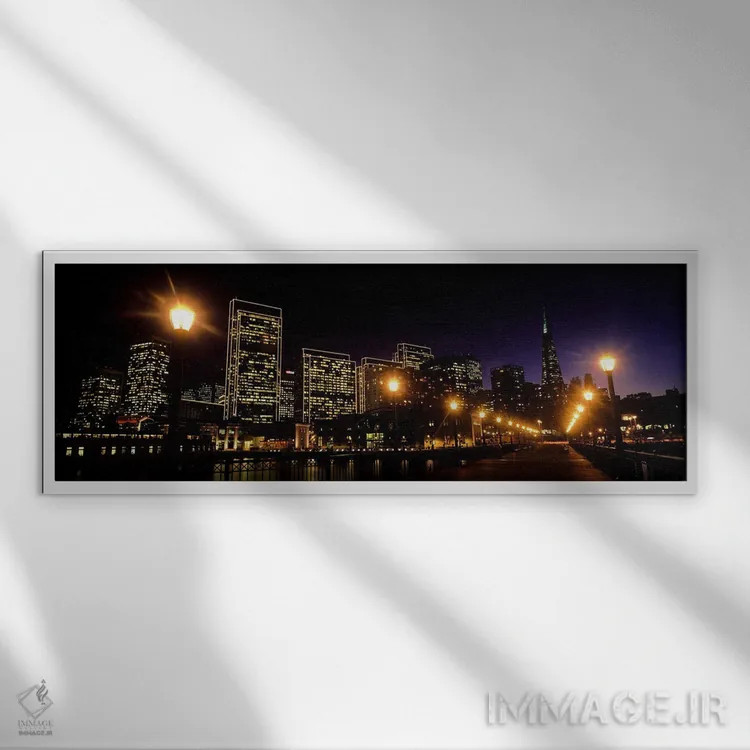 تابلو دکوراتیو ساختمان ها در کنار آب روشن شده در شب، سانفرانسیسکو، کال… اثر پانورامیک ایمجز - نمای قابدار سفید