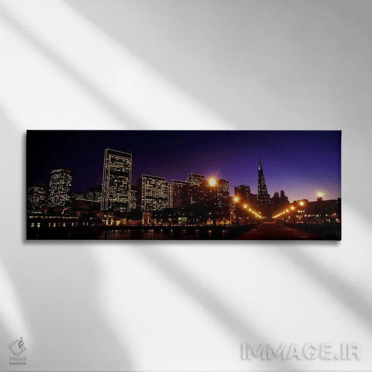 تابلو دکوراتیو ساختمان ها در کنار آب روشن شده در غروب، سانفرانسیسکو، ک… اثر پانورامیک ایمجز - نمای روبهرو روی دیوار