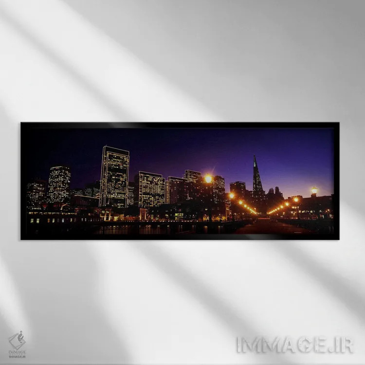 تابلو دکوراتیو ساختمان ها در کنار آب روشن شده در غروب، سانفرانسیسکو، ک… اثر پانورامیک ایمجز - نمای قابدار مشکی