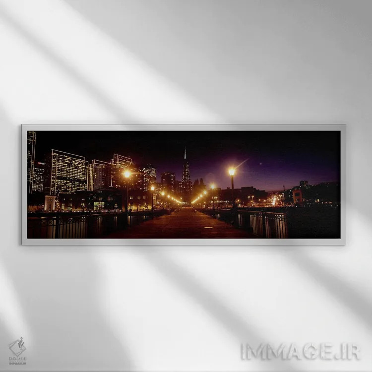تابلو دکوراتیو ساختمان ها در کنار آب روشن شده در شب، سانفرانسیسکو، کال… اثر پانورامیک ایمجز - نمای قابدار سفید
