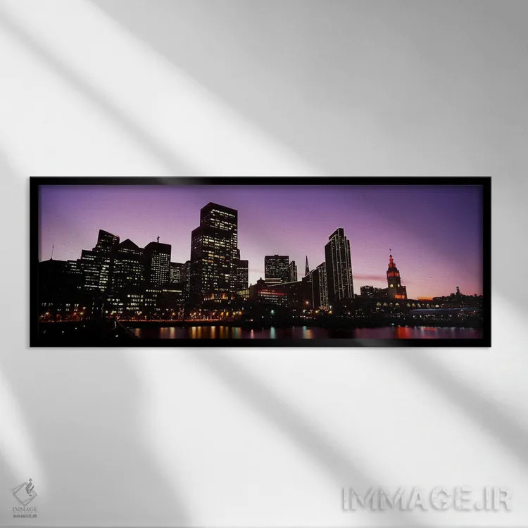 تابلو دکوراتیو ساختمان ها در کنار آب روشن شده در غروب، سانفرانسیسکو، ک… اثر پانورامیک ایمجز - نمای قابدار مشکی