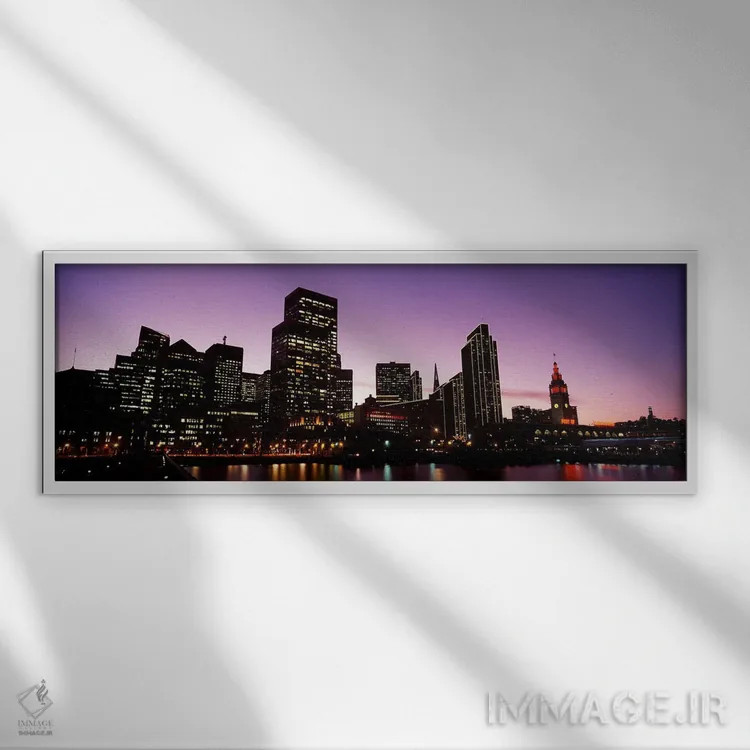 تابلو دکوراتیو ساختمان ها در کنار آب روشن شده در غروب، سانفرانسیسکو، ک… اثر پانورامیک ایمجز - نمای قابدار سفید
