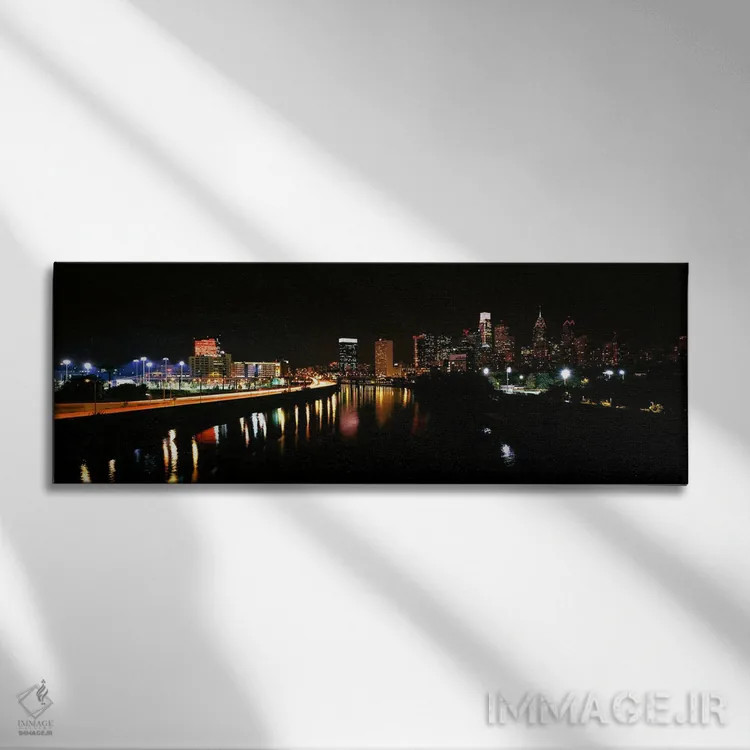 تابلو دکوراتیو ساختمان ها روشن شده در کنار آب، فیلادلفیا، رودخانه شیکی… اثر پانورامیک ایمجز - نمای روبهرو روی دیوار
