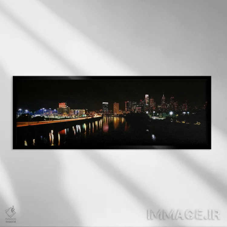 تابلو دکوراتیو ساختمان ها روشن شده در کنار آب، فیلادلفیا، رودخانه شیکی… اثر پانورامیک ایمجز - نمای قابدار مشکی