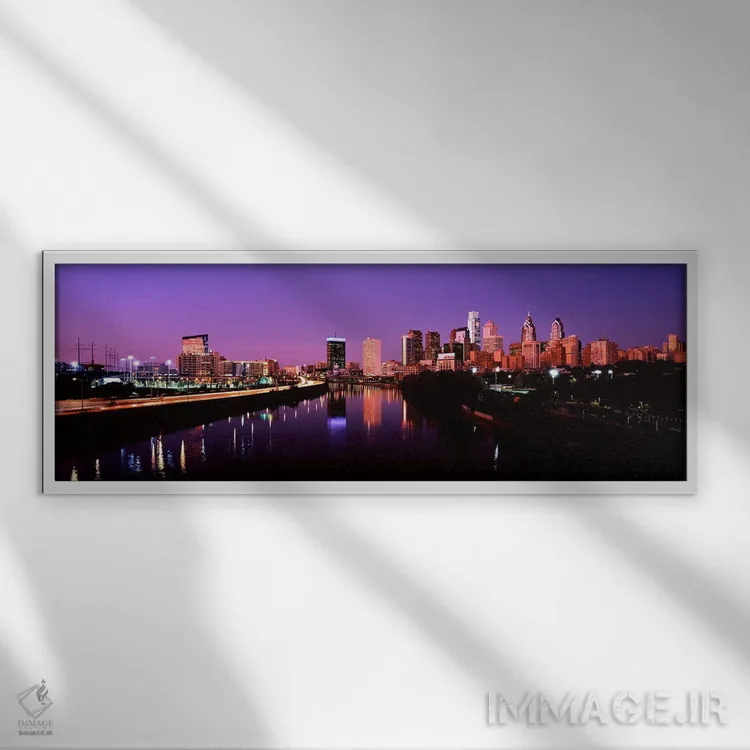 تابلو دکوراتیو ساختمان ها روشن شده در کنار آب، فیلادلفیا، رودخانه شیکی… اثر پانورامیک ایمجز - نمای قابدار سفید