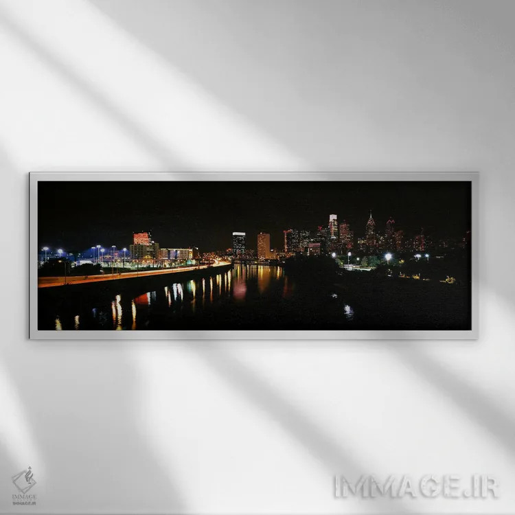 تابلو دکوراتیو ساختمان ها روشن شده در کنار آب، فیلادلفیا، رودخانه شیکی… اثر پانورامیک ایمجز - نمای قابدار سفید