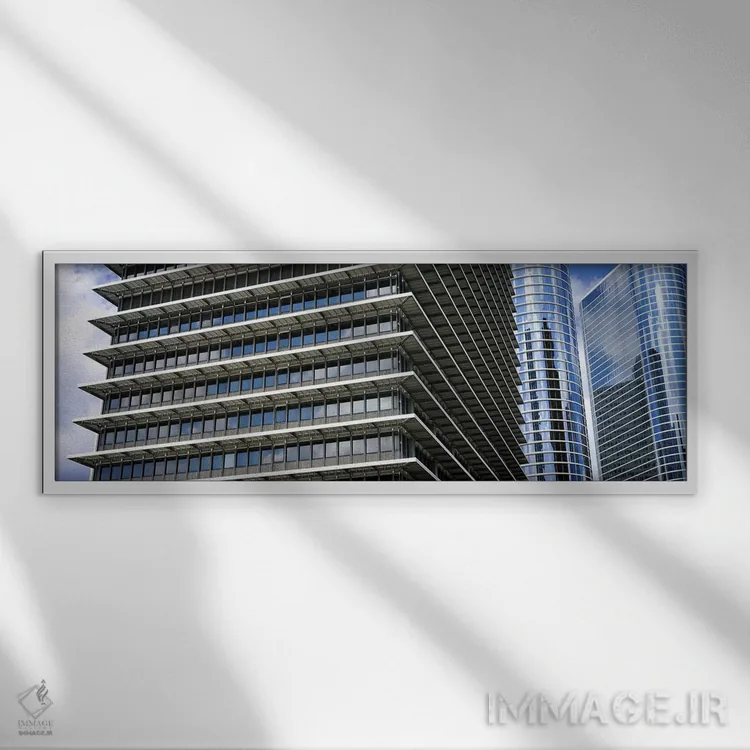 تابلو دکوراتیو نمای پایین از ساختمان ها در یک شهر، ساختمان اکسون موبیل… اثر پانورامیک ایمجز - نمای قابدار سفید