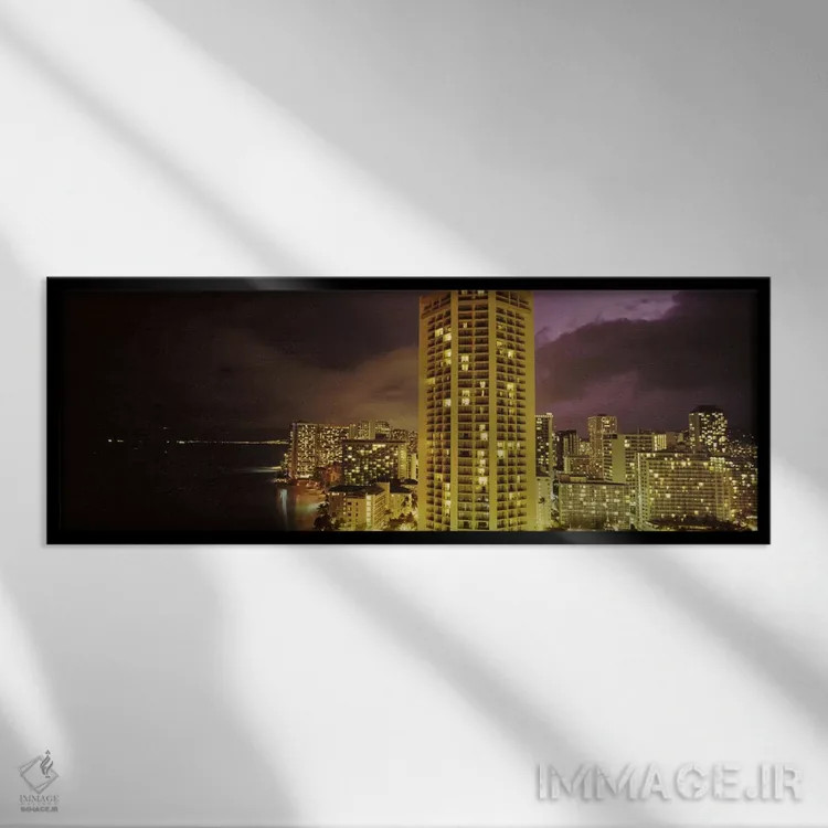 تابلو دکوراتیو ساختمان ها که در شب روشن شده اند، هونولولو، اوهاو، هاوا… اثر پانورامیک ایمجز - نمای قابدار مشکی