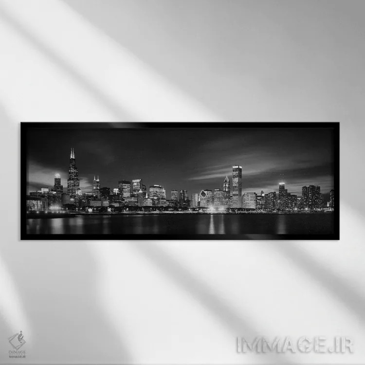 تابلو دکوراتیو نمای آسمان خراش های مرکز شهر در شب به صورت سیاه و سفید… اثر پانورامیک ایمجز - نمای قابدار مشکی
