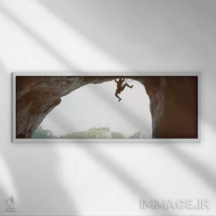 تابلو دکوراتیو سایه روشن مردی که در حال صعود از یک صخره است، ساحل رایل… اثر پانورامیک ایمجز - نمای قابدار سفید