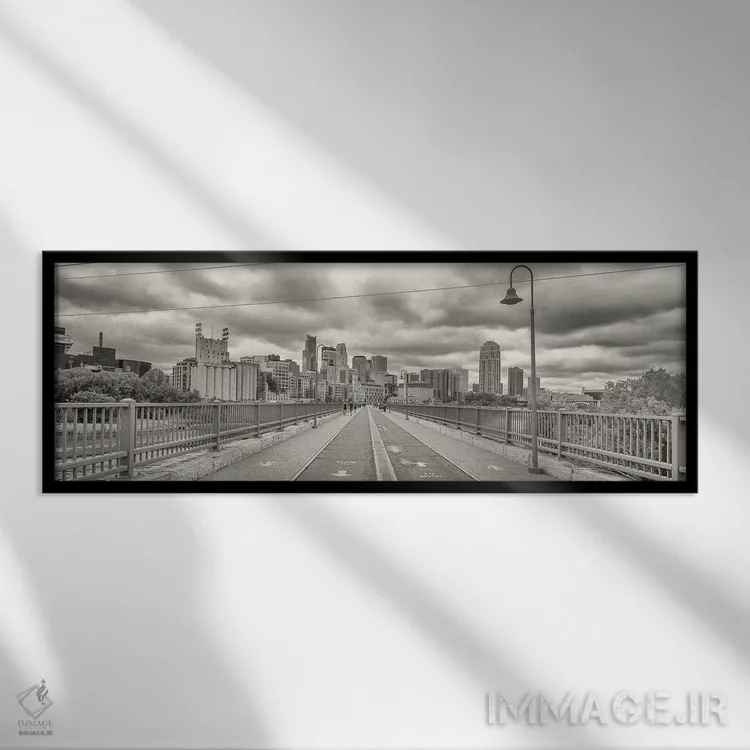 تابلو دکوراتیو "پل قوسی سنگی با ساختمان هایی در پس زمینه، منطقه میل، م… اثر پانورامیک ایمجز - نمای قابدار مشکی
