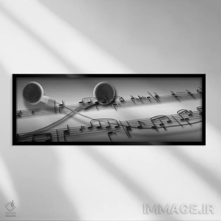 تابلو دکوراتیو نت های موسیقی قرار گرفته روی هدفون اثر پانورامیک ایمجز - نمای قابدار مشکی